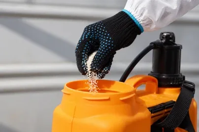 Technician preparing disinfection equipment for a professional water tank disinfection service